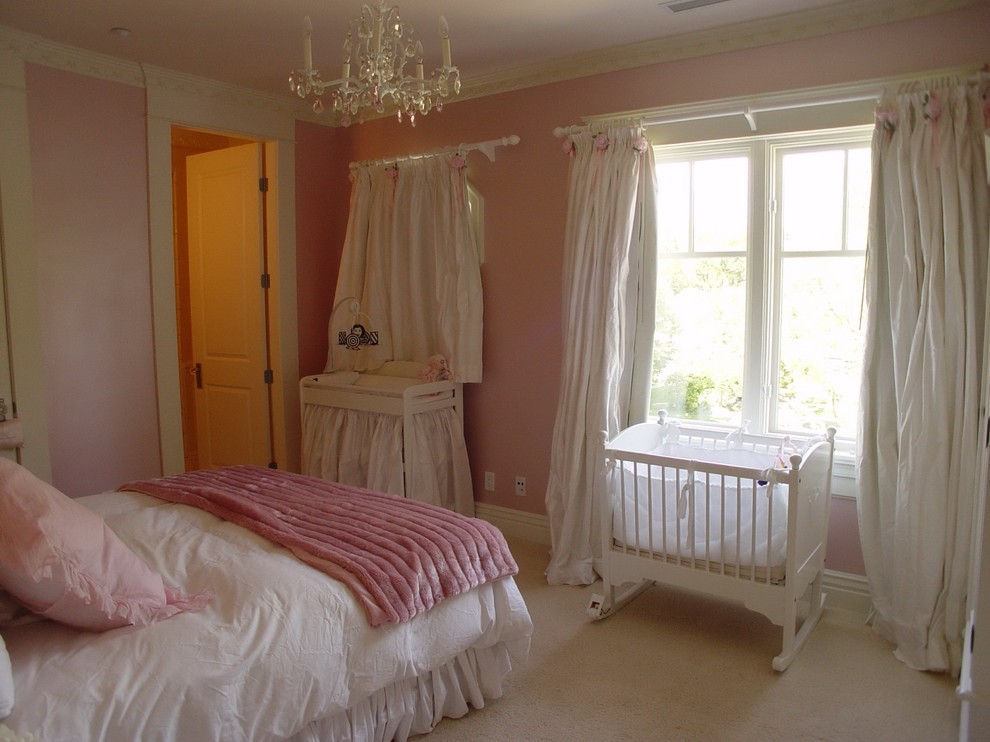 This is an example of a mid-sized traditional nursery for girls in Vancouver with pink walls and carpet.