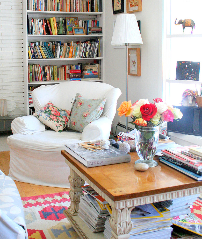 Eclectic living room in Burlington with a library and white walls.