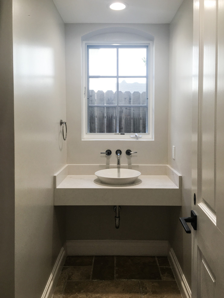 Photo of a small modern powder room in Los Angeles with a one-piece toilet, brown tile, grey walls, a vessel sink, engineered quartz benchtops, ceramic tile and ceramic floors.