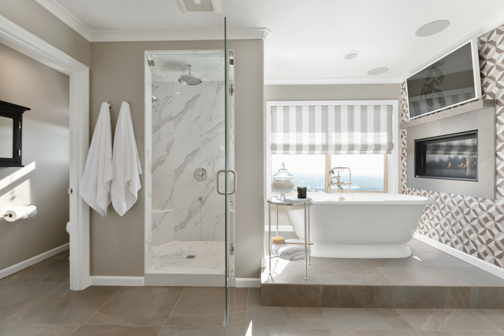 Inspiration for a large transitional master bathroom in Portland with a freestanding tub, gray tile, grey walls, porcelain floors, grey floor, an alcove shower and a hinged shower door.