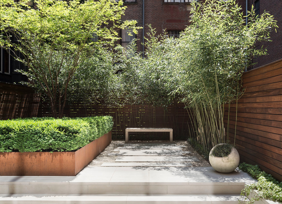 Design ideas for a small modern backyard partial sun garden in New York with a garden path and natural stone pavers.