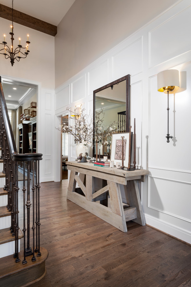 Large transitional medium tone wood floor and brown floor entry hall photo in Detroit with white walls