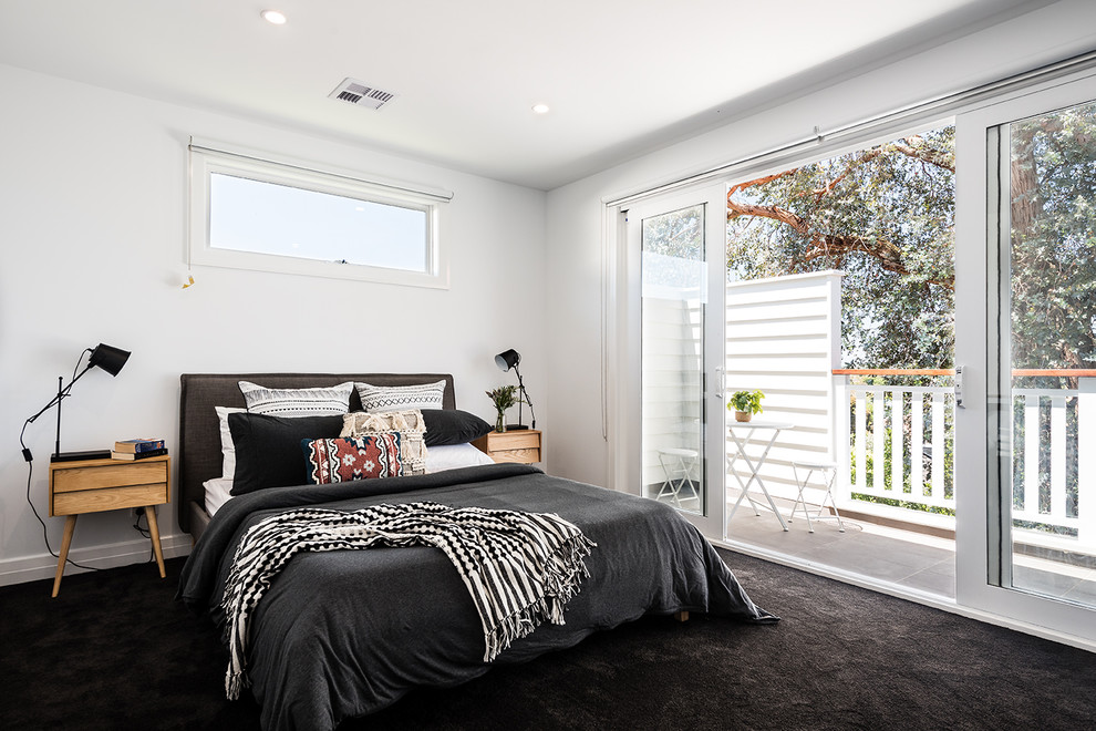Mid-sized contemporary bedroom in Melbourne with white walls, carpet and black floor.