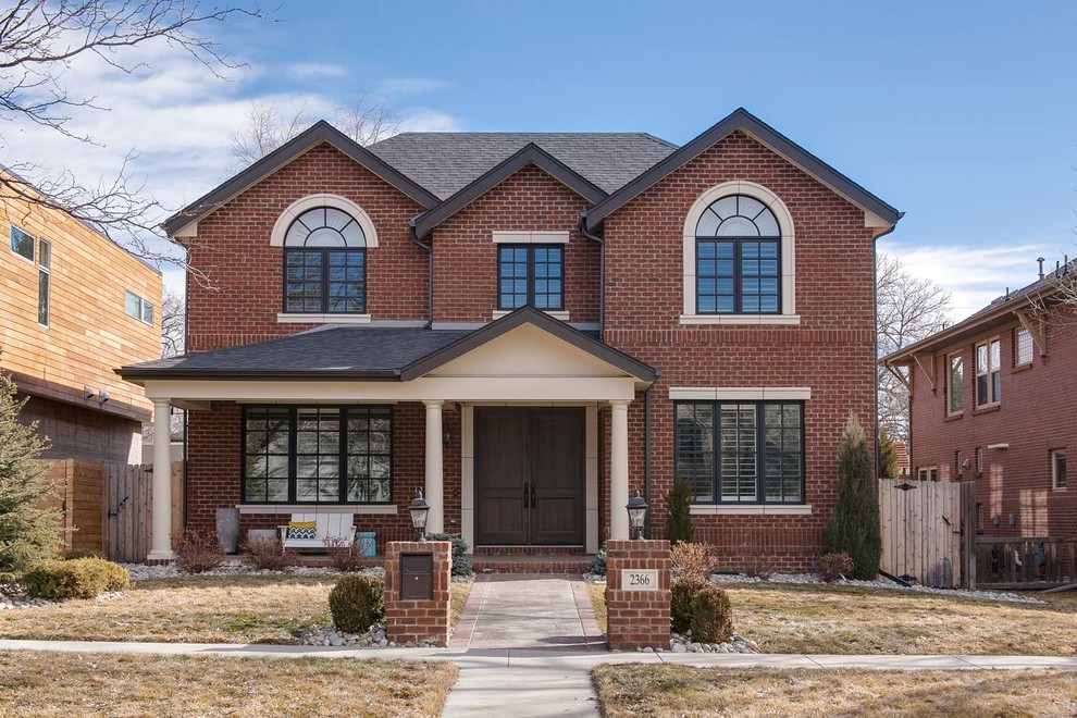 Mid-sized transitional two-storey brick brown house exterior in Denver with a clipped gable roof.