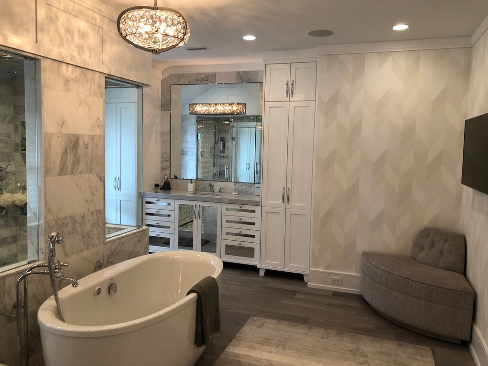 Large transitional master bathroom in Philadelphia with recessed-panel cabinets, white cabinets, a freestanding tub, a corner shower, white tile, marble, white walls, dark hardwood floors, an undermount sink, engineered quartz benchtops, brown floor, a hinged shower door and white benchtops.