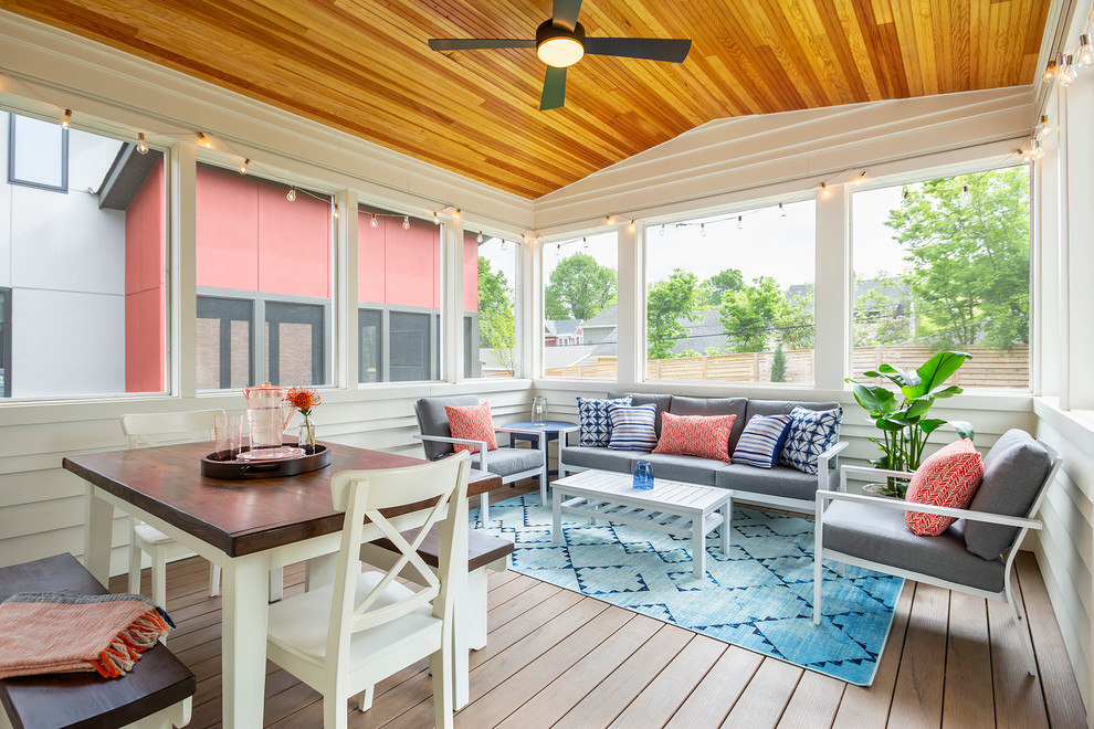 Mid-sized transitional screened-in verandah in Minneapolis with decking and a roof extension.
