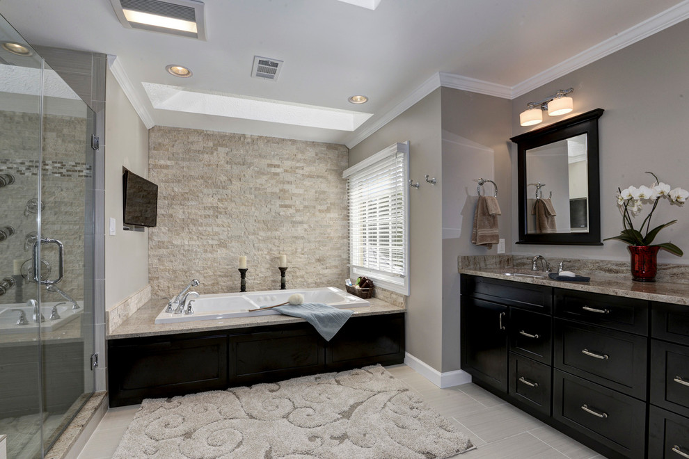 This is an example of a mid-sized contemporary master bathroom in DC Metro with shaker cabinets, black cabinets, a hot tub, an alcove shower, gray tile, porcelain tile, brown walls, porcelain floors, an undermount sink, granite benchtops, grey floor and a hinged shower door.