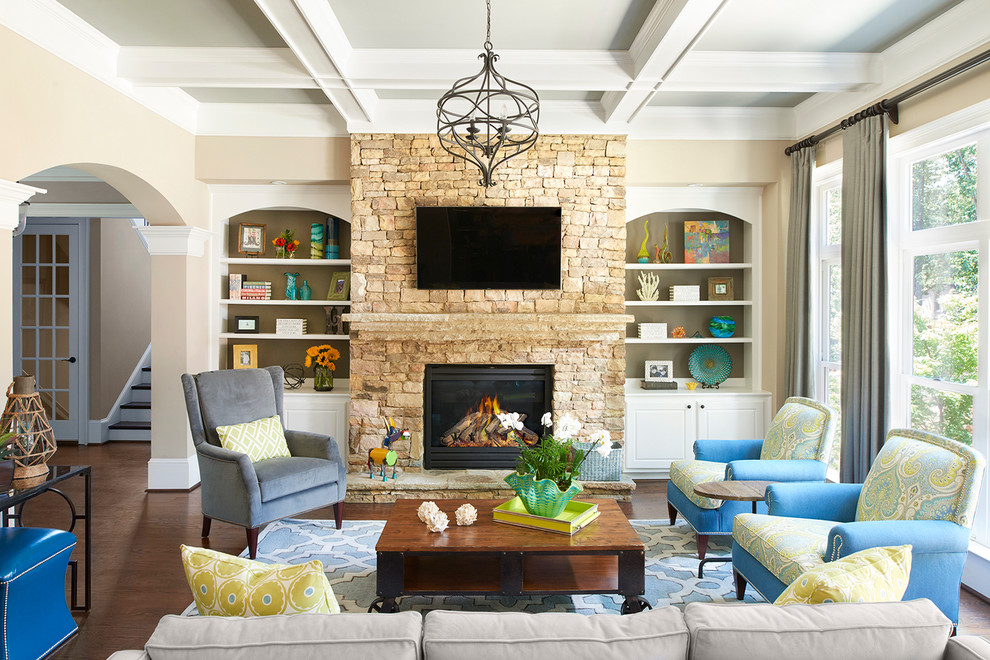 This is an example of a large transitional open concept living room in Atlanta with beige walls, dark hardwood floors, a standard fireplace, a stone fireplace surround, a wall-mounted tv and brown floor.
