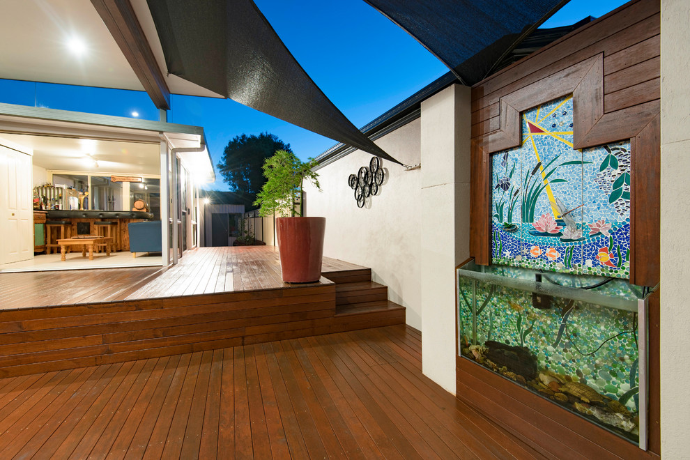 This is an example of a large contemporary backyard deck in Canberra - Queanbeyan with a vertical garden and a pergola.