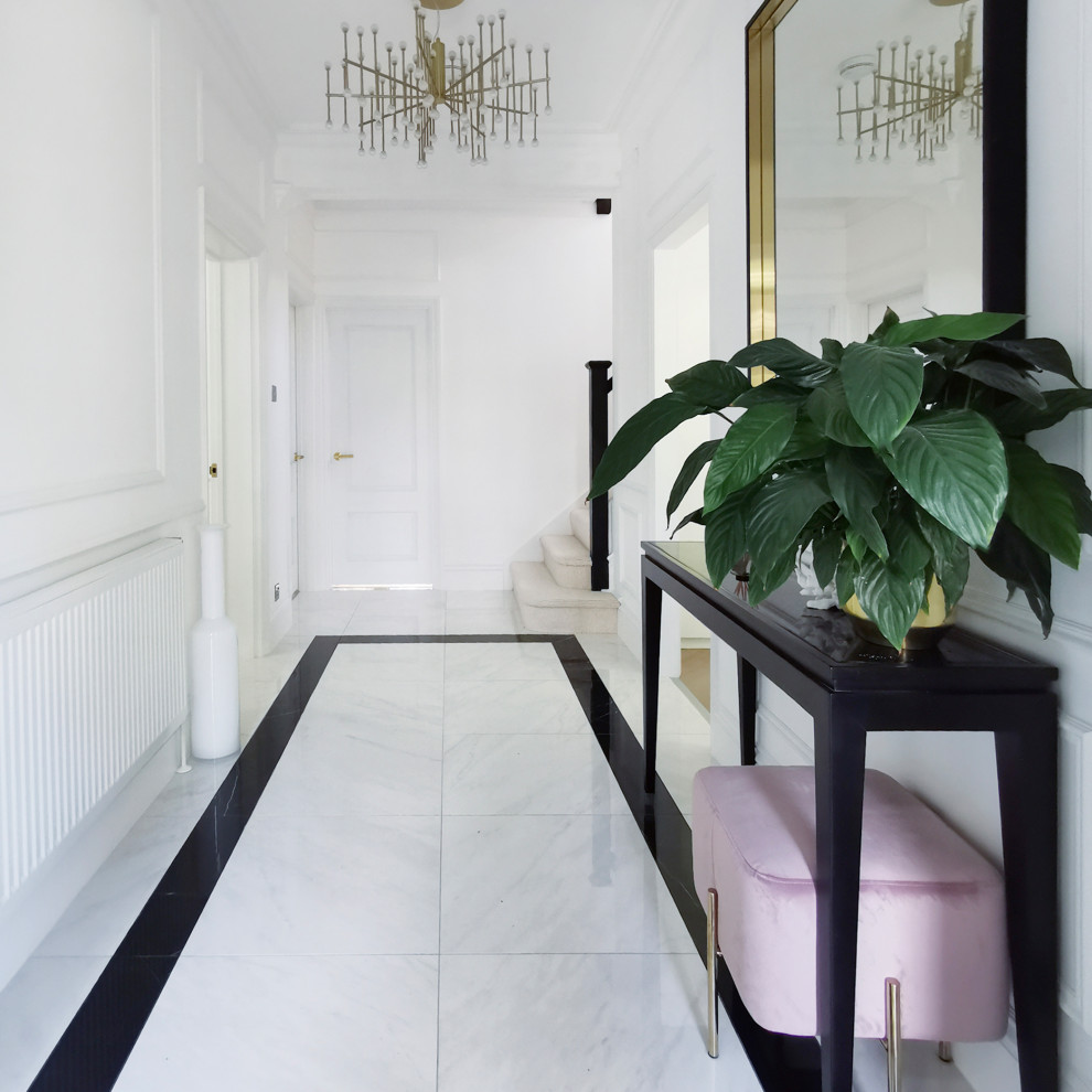 Large minimalist porcelain tile hallway photo in London with white walls