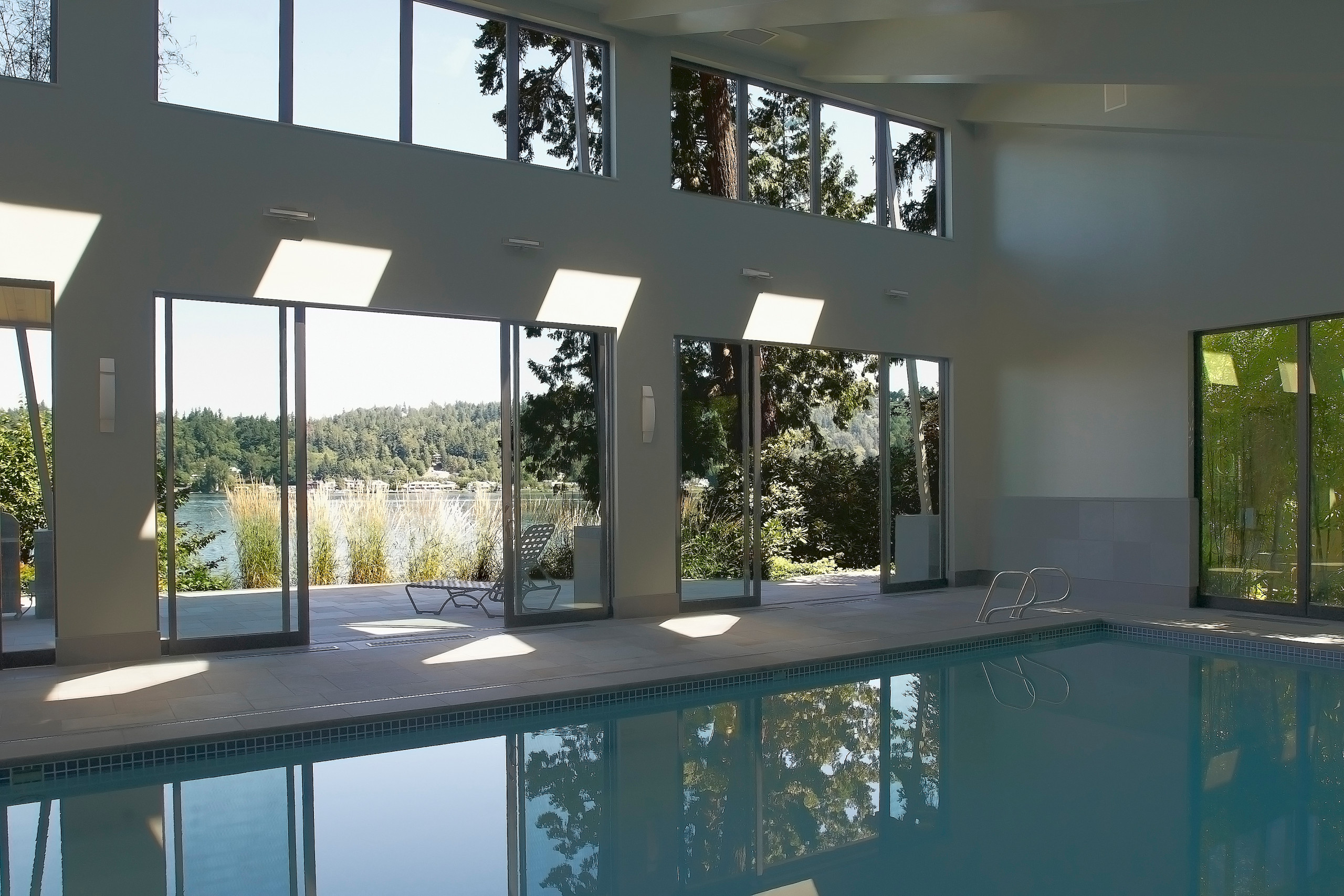 Pool House interior - cut stone wainscoat, paving, and pool coping