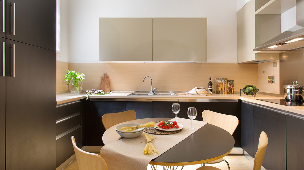 Mid-sized contemporary u-shaped eat-in kitchen in Florence with a double-bowl sink, flat-panel cabinets, wood benchtops, beige splashback, no island and beige cabinets.