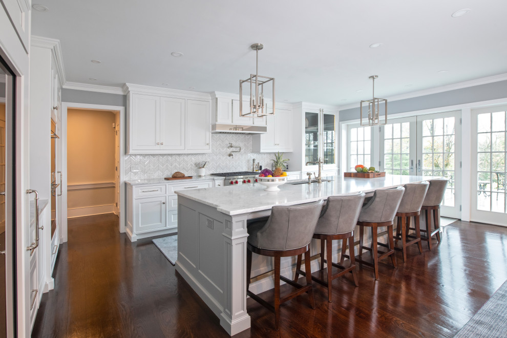 Inspiration for a large timeless l-shaped brown floor eat-in kitchen remodel in Philadelphia with shaker cabinets, white cabinets, white backsplash, an island and white countertops