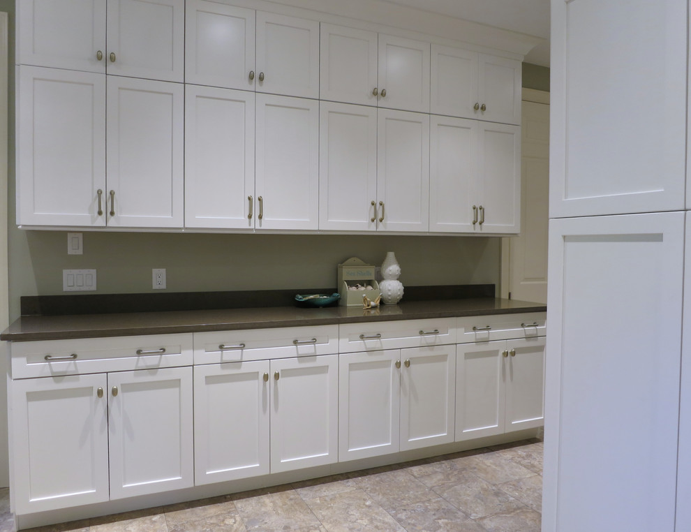 Design ideas for an expansive utility room in Atlanta with an undermount sink, shaker cabinets, white cabinets, quartz benchtops, green walls, ceramic floors and a side-by-side washer and dryer.