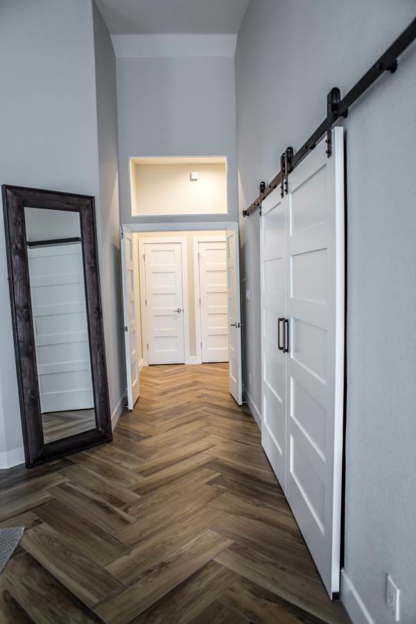 Mid-sized transitional hallway in Phoenix with beige walls and light hardwood floors.