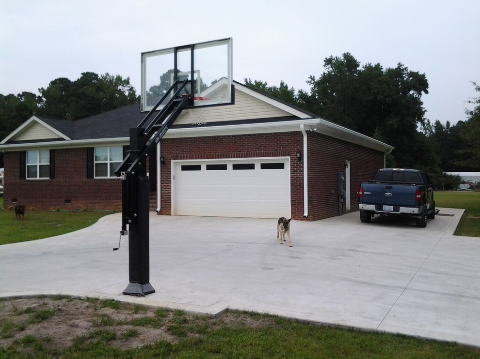 This is an example of a large traditional front yard partial sun outdoor sport court in Raleigh.