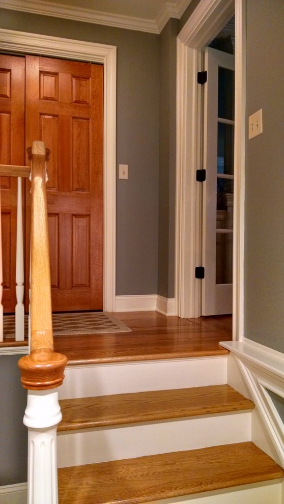 Photo of a small transitional mudroom in New York with blue walls, porcelain floors, a single front door, a metal front door and multi-coloured floor.