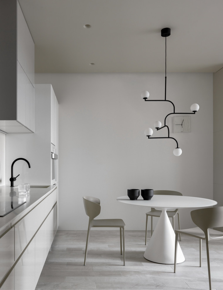Design ideas for a mid-sized contemporary single-wall separate kitchen in Moscow with an undermount sink, flat-panel cabinets, beige cabinets, quartz benchtops, beige splashback, white appliances, porcelain floors, no island, beige floor and beige benchtop.
