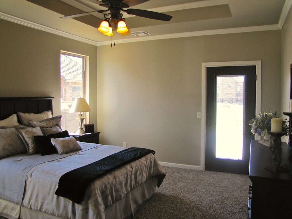Large transitional master bedroom in Oklahoma City with beige walls and carpet.