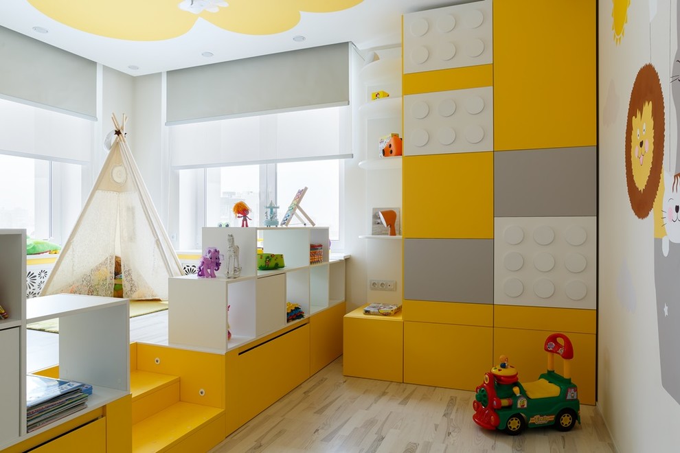 This is an example of a contemporary gender-neutral kids' room in Saint Petersburg with light hardwood floors, beige floor and multi-coloured walls.