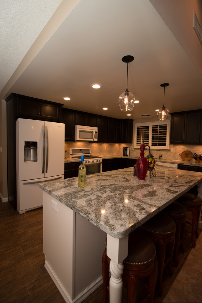 Inspiration for a mid-sized transitional l-shaped porcelain tile open concept kitchen remodel with an undermount sink, flat-panel cabinets, dark wood cabinets, quartz countertops, beige backsplash, glass sheet backsplash, white appliances and an island