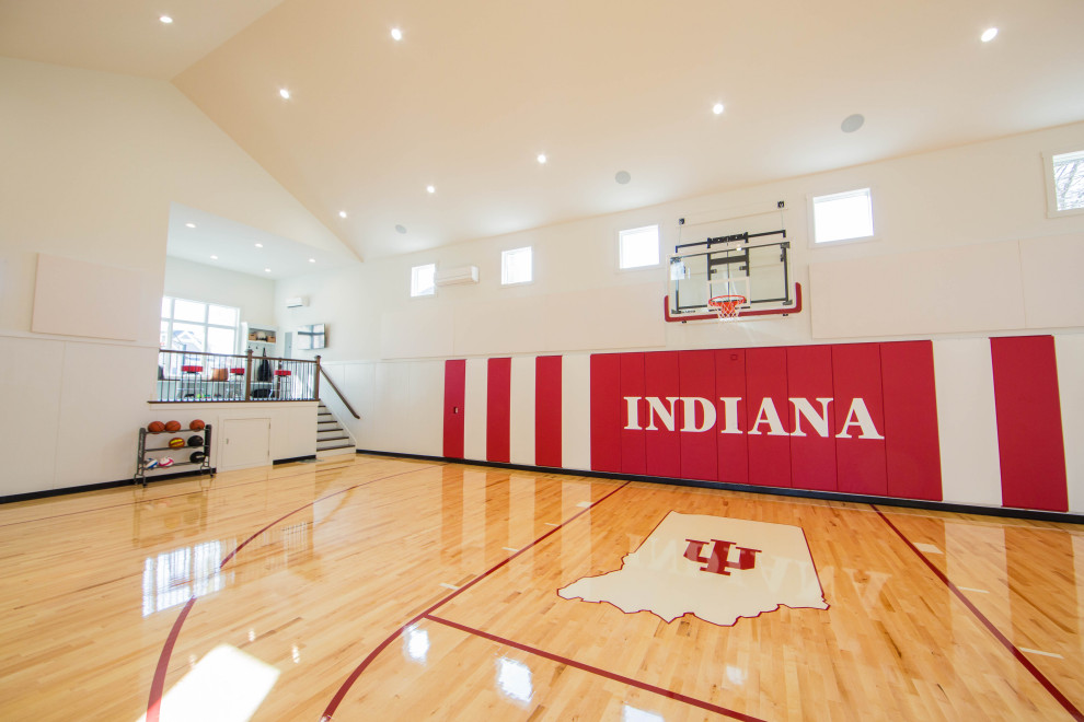 Indoor sport court - huge traditional painted wood floor, multicolored floor and vaulted ceiling indoor sport court idea in Indianapolis with white walls