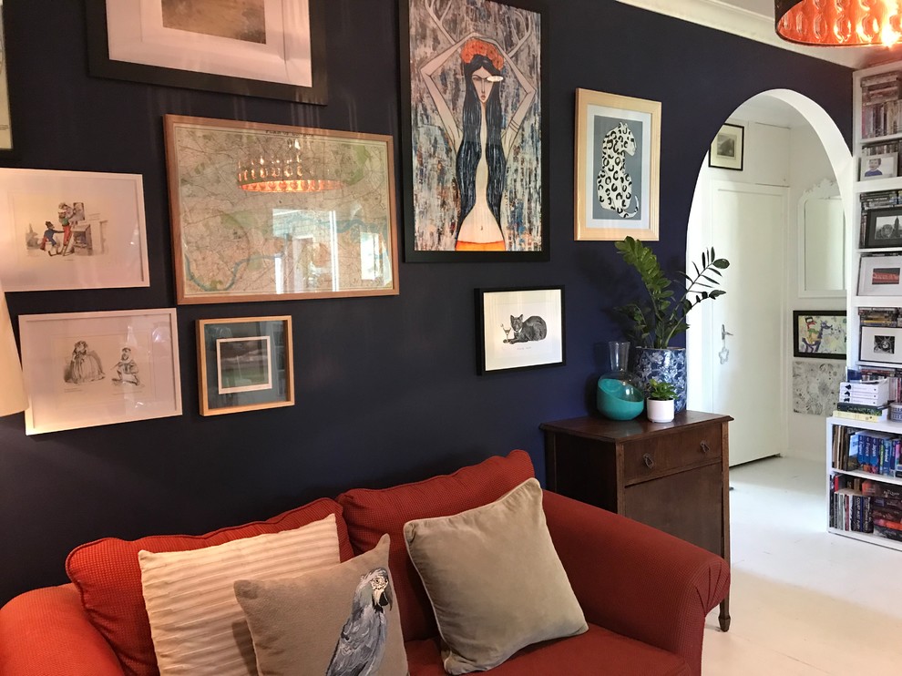 This is an example of an eclectic living room in Melbourne with blue walls, painted wood floors and white floor.
