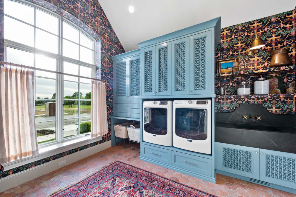 Photo of a traditional laundry room in Salt Lake City with terra-cotta floors and wallpaper.