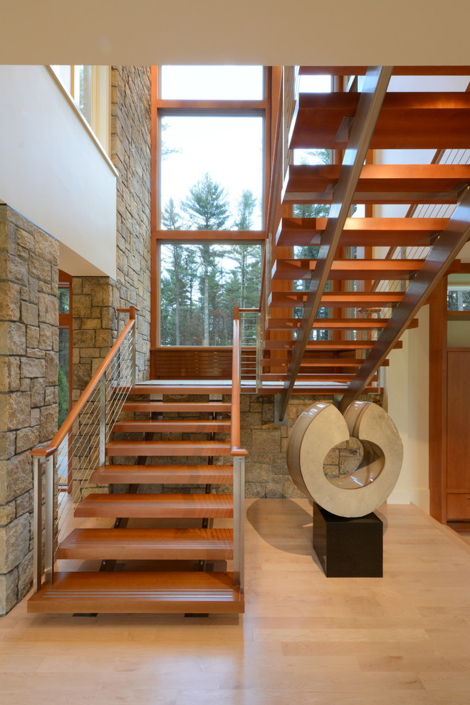 Photo of a contemporary wood u-shaped staircase in Boston with open risers.