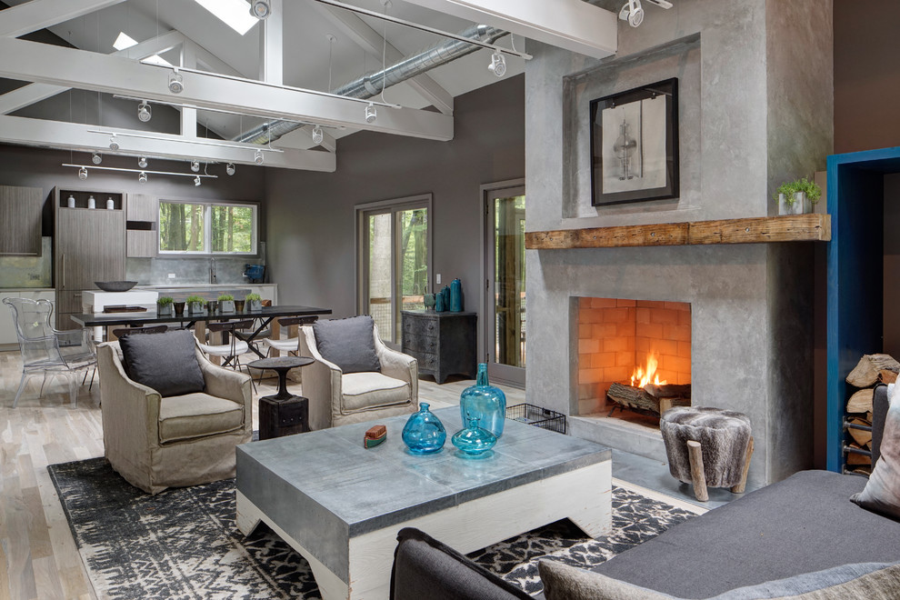 Photo of a large contemporary open concept living room in Chicago with grey walls, light hardwood floors, a standard fireplace, a concrete fireplace surround and beige floor.