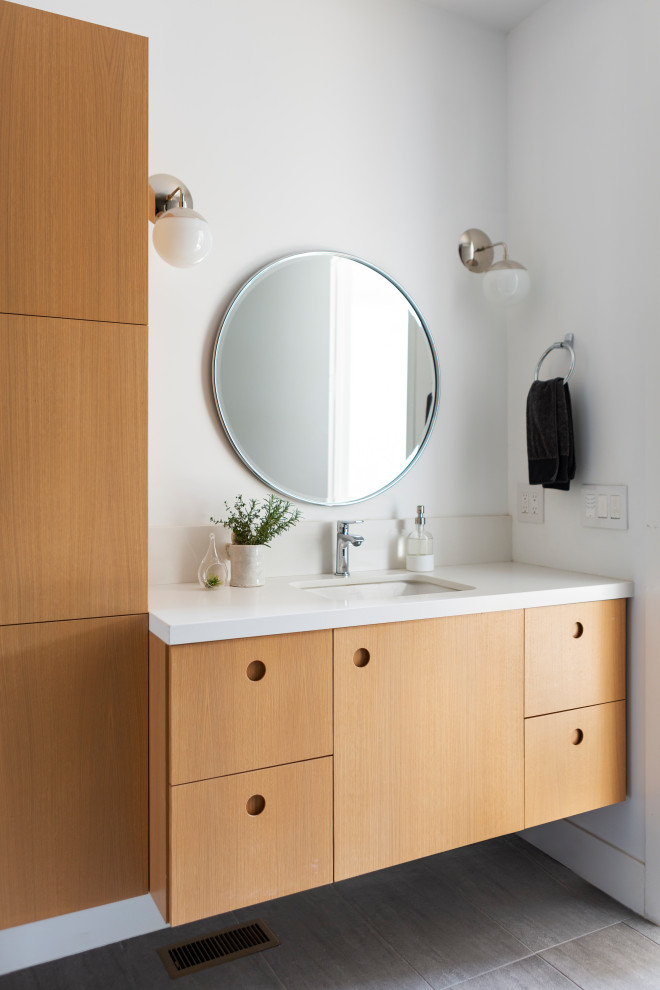 Scandinavian bathroom in San Francisco with flat-panel cabinets, light wood cabinets, white walls, a submerged sink, grey floors, white worktops, a single sink and a floating vanity unit.