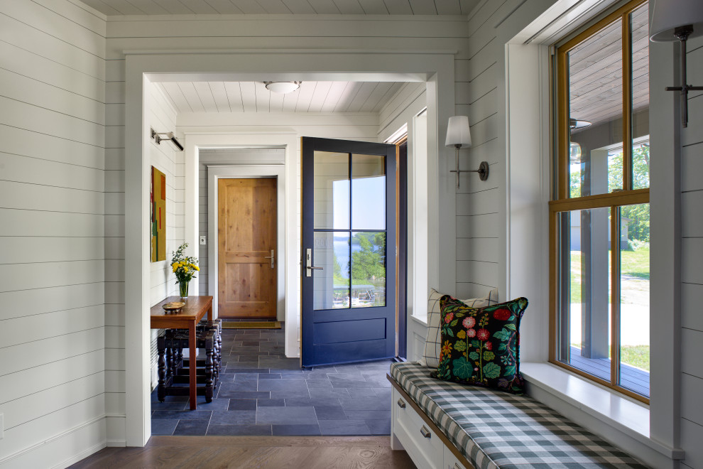 Example of a beach style slate floor, gray floor, shiplap ceiling and shiplap wall single front door design in Minneapolis with white walls and a black front door