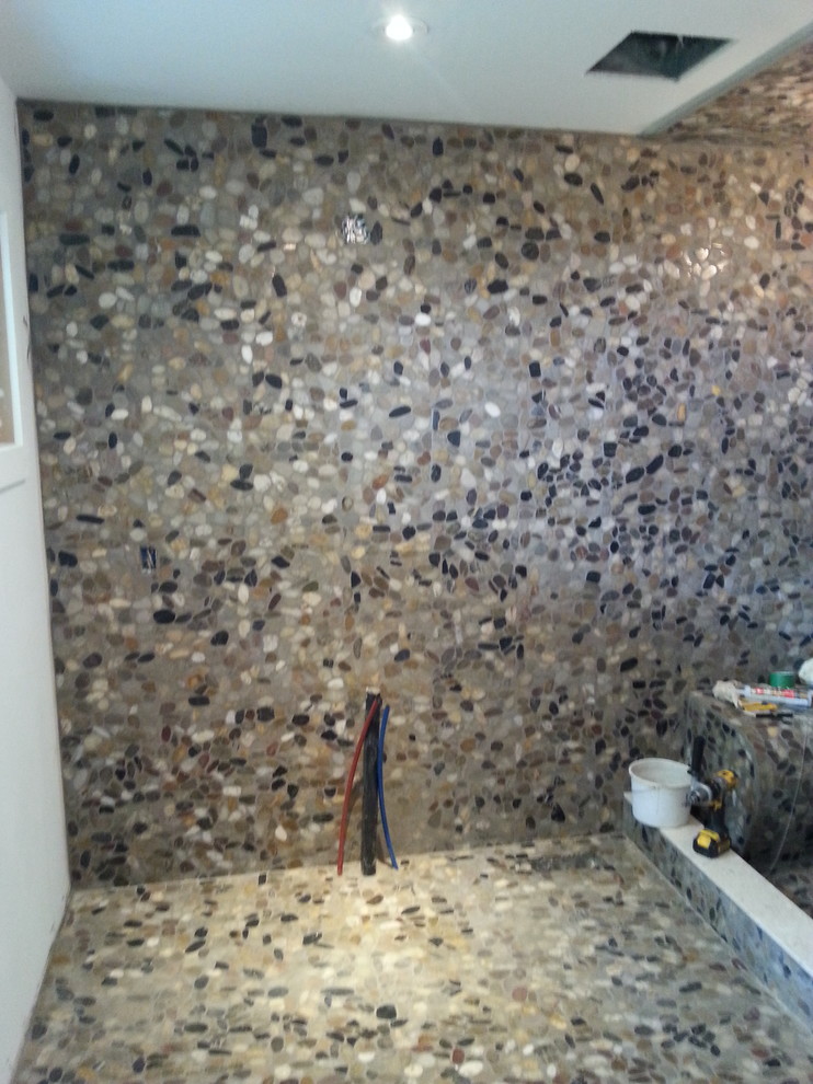 Photo of a large country master bathroom in Toronto with an alcove shower, multi-coloured tile, pebble tile and pebble tile floors.