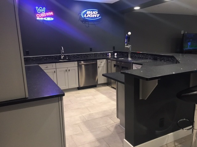 Modern wet bar in Other with an undermount sink, shaker cabinets, quartz benchtops, black splashback, ceramic splashback, grey cabinets and ceramic floors.