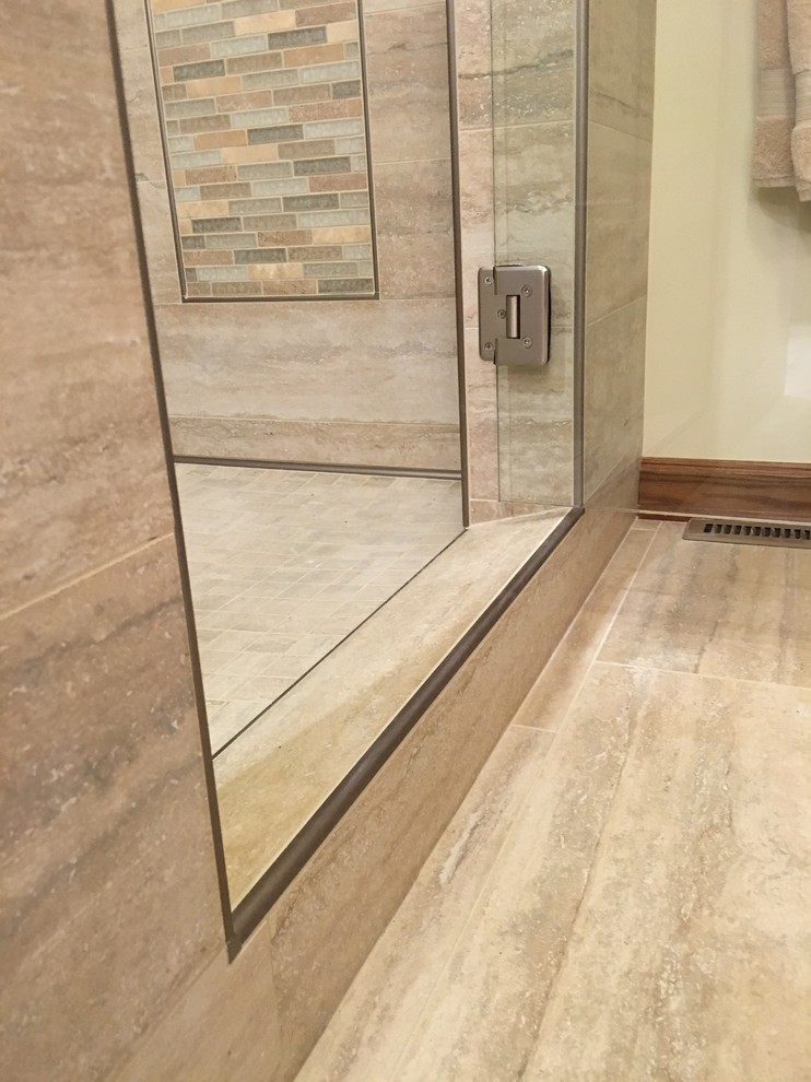 Large transitional master beige tile and porcelain tile porcelain tile double shower photo with shaker cabinets, medium tone wood cabinets, beige walls, an undermount sink and granite countertops