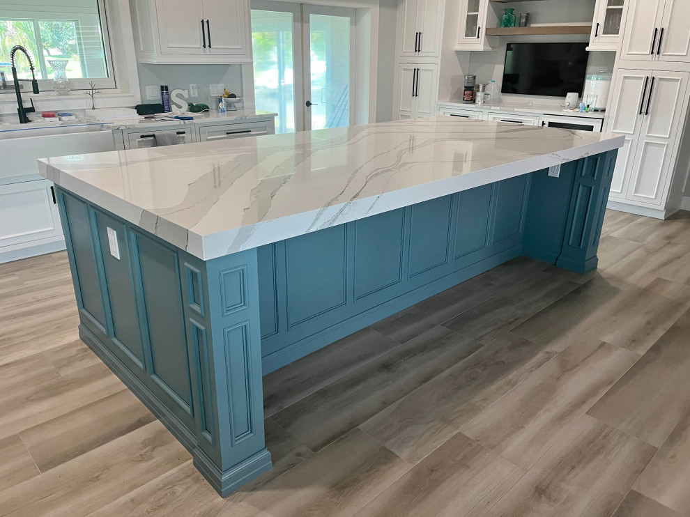Mid-sized transitional l-shaped eat-in kitchen in Other with a farmhouse sink, beaded inset cabinets, blue cabinets, quartz benchtops and with island.