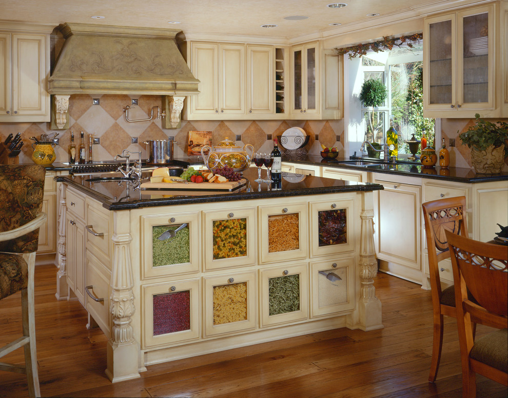 Design ideas for a traditional kitchen in Other with an undermount sink, glass-front cabinets, beige cabinets and multi-coloured splashback.