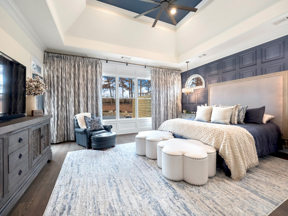 Inspiration for a large transitional master medium tone wood floor, gray floor, tray ceiling and wallpaper bedroom remodel in Other with blue walls and no fireplace