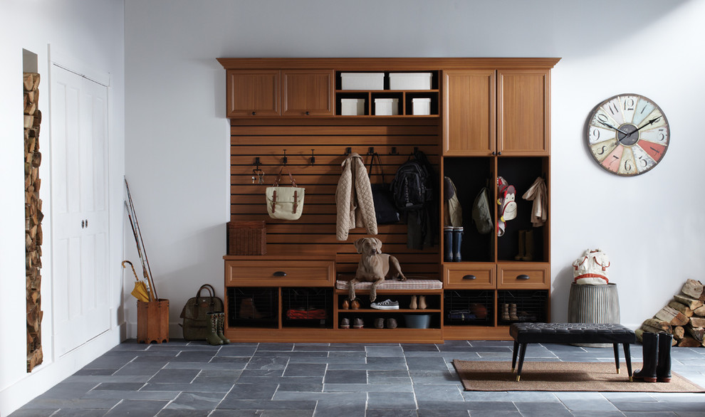Example of a mid-sized mountain style slate floor mudroom design with white walls and a white front door