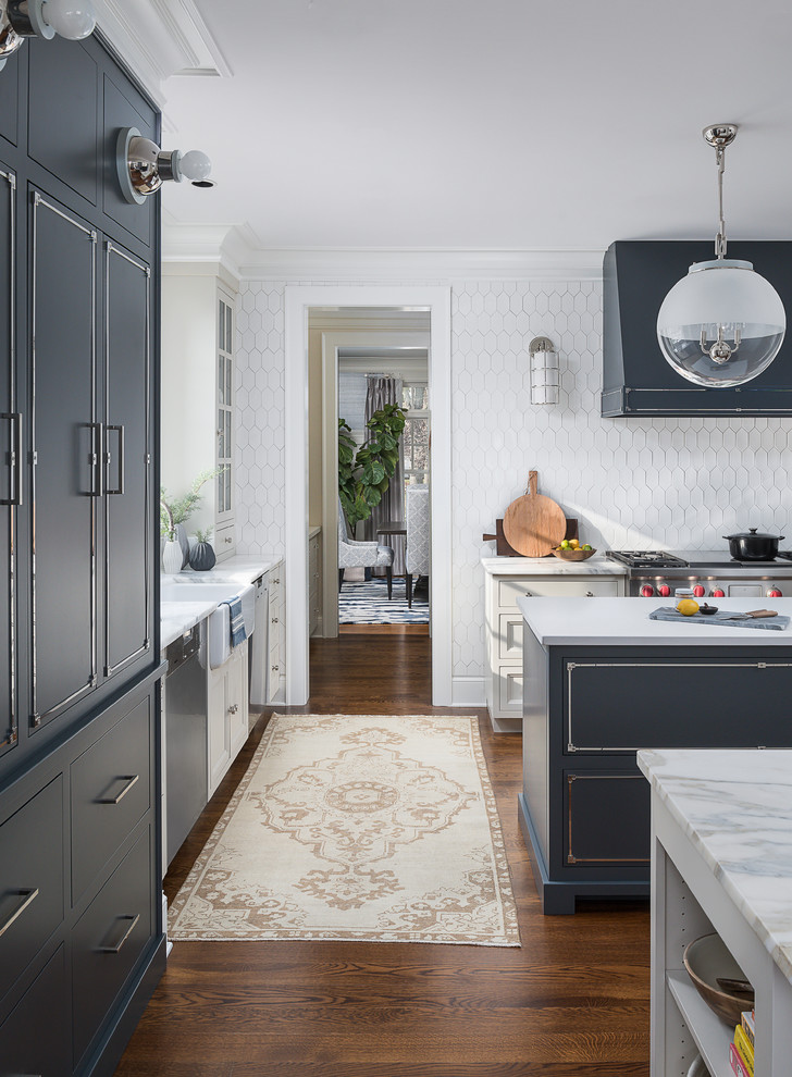 Inspiration for a large transitional medium tone wood floor and brown floor kitchen remodel in Chicago with a farmhouse sink, beaded inset cabinets, blue cabinets, marble countertops, white backsplash, ceramic backsplash, stainless steel appliances, two islands and yellow countertops