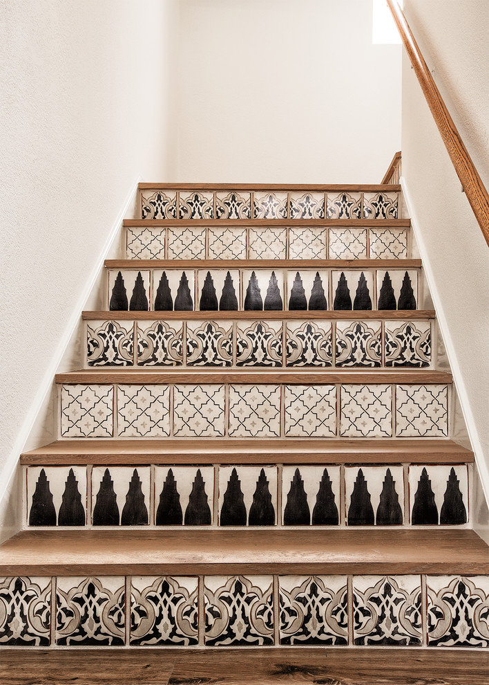This is an example of a small contemporary wood u-shaped staircase in Phoenix with tile risers.