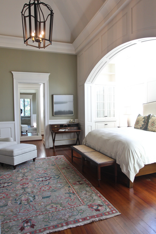 Traditional bedroom in Charleston with grey walls and medium hardwood floors.