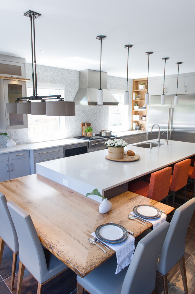 Inspiration for a large contemporary u-shaped eat-in kitchen in Toronto with an undermount sink, flat-panel cabinets, grey cabinets, quartz benchtops, grey splashback, stone tile splashback, stainless steel appliances, porcelain floors and with island.