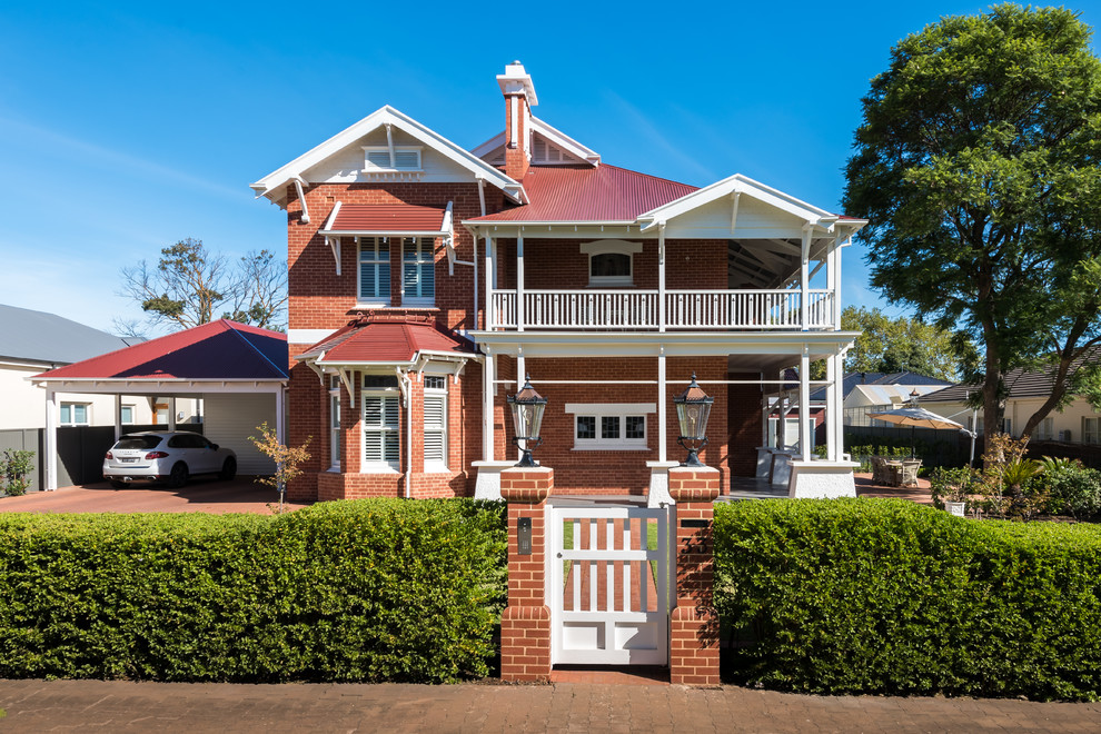 Large traditional two-storey brick red house exterior in Adelaide with a hip roof and a metal roof.