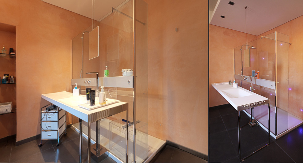 Inspiration for a mid-sized contemporary 3/4 bathroom in Turin with white cabinets, an open shower, a wall-mount toilet, orange tile, white walls, porcelain floors, a console sink and quartzite benchtops.