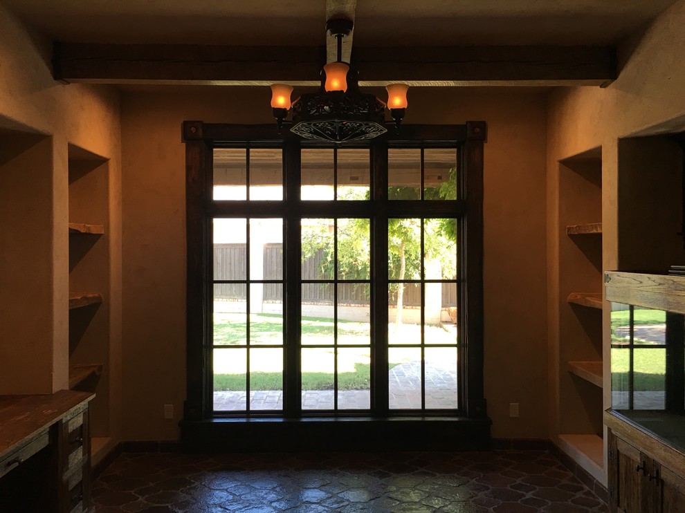 Example of a mountain style built-in desk home design design in Austin with beige walls