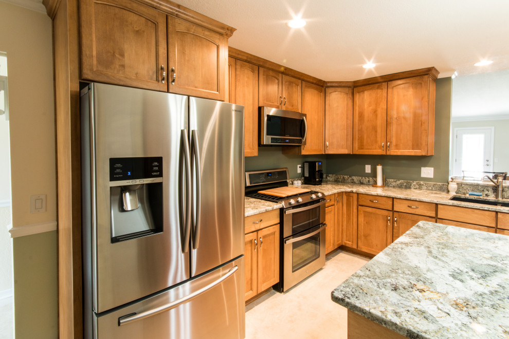 Eat-in kitchen - mid-sized l-shaped cement tile floor eat-in kitchen idea with an undermount sink, flat-panel cabinets, medium tone wood cabinets, granite countertops, stainless steel appliances and an island