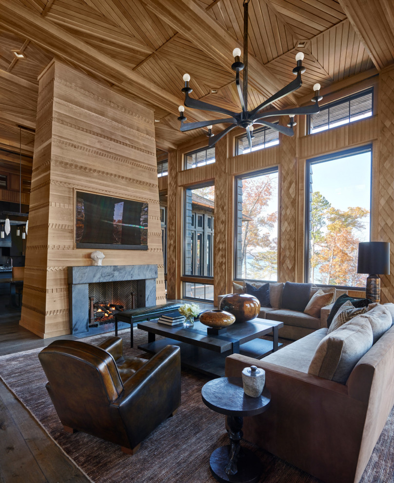 Inspiration for a large rustic open concept wood ceiling, dark wood floor, brown floor and wood wall living room remodel in Other with a standard fireplace, a stone fireplace, a wall-mounted tv and brown walls