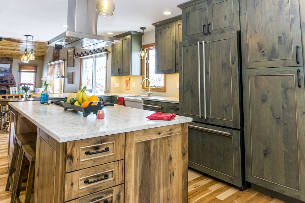 Large mountain style light wood floor and brown floor open concept kitchen photo with beaded inset cabinets, distressed cabinets, granite countertops, an island and white countertops