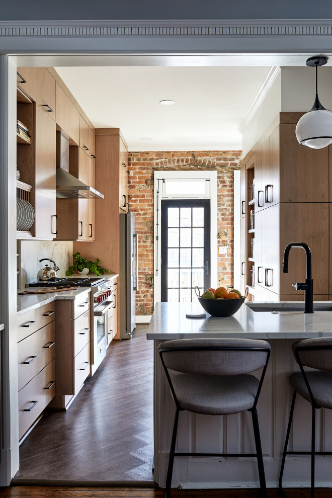 Design ideas for a mid-sized transitional eat-in kitchen in DC Metro with beige cabinets, white splashback, stainless steel appliances, a peninsula and white benchtop.